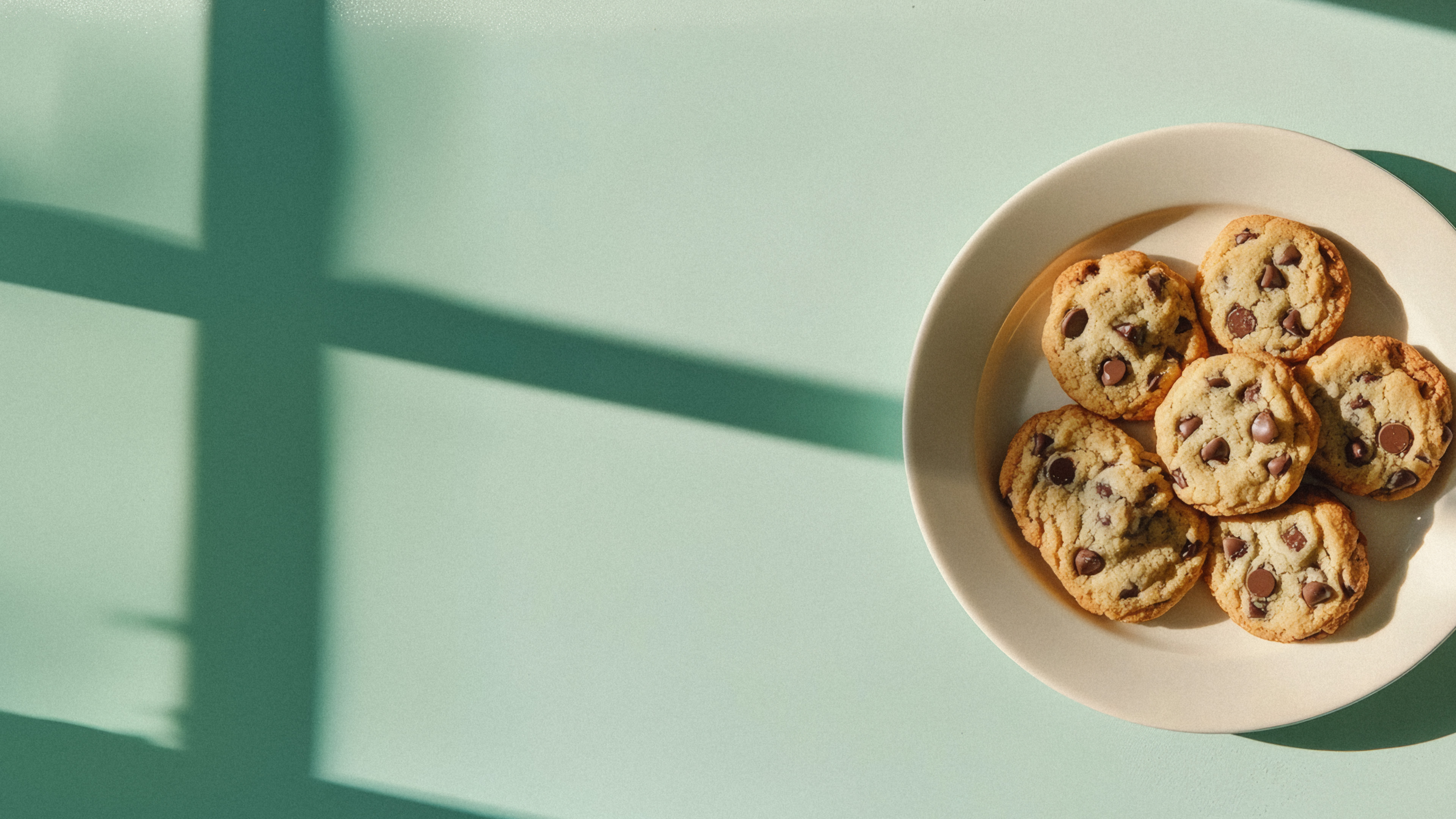 A hand holding a rechargeable vape unit in the woods.